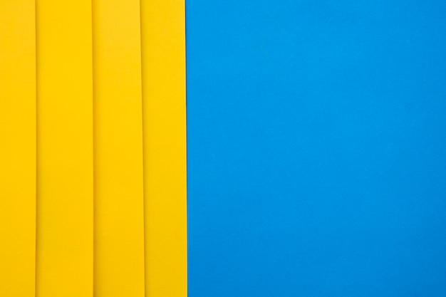 Foto gratuita vista de ángulo alto de craftpapers amarillo sobre fondo azul