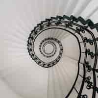 Foto gratuita vista de ángulo alto de una moderna escalera de caracol bajo las luces