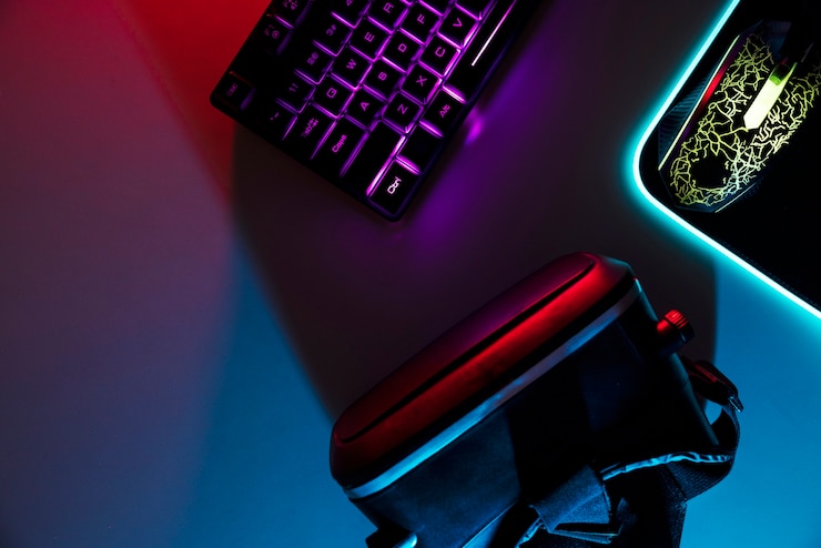 Foto gratuito vista de la configuración de la mesa de juego iluminada con neón con teclado