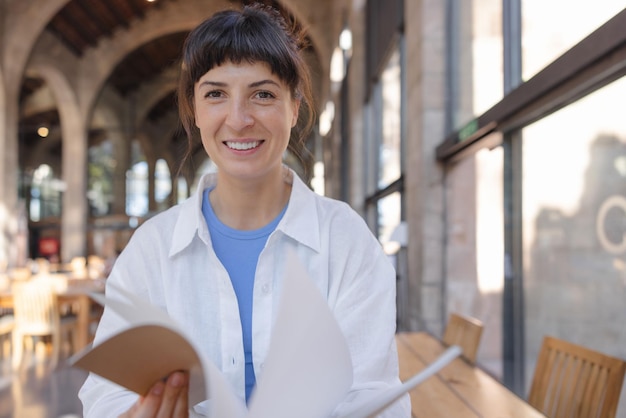 Vista de estudiante linda mujer sonriendo a la cámara