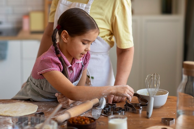 Foto gratuita vista frontal abuela y niña cocinando juntas