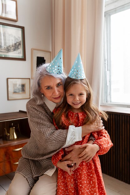 Vista frontal anciana y niña celebrando cumpleaños