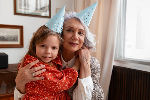 Vista frontal anciana y niña celebrando cumpleaños