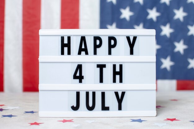 Vista frontal de la bandera de Estados Unidos con feliz cartel del 4 de julio