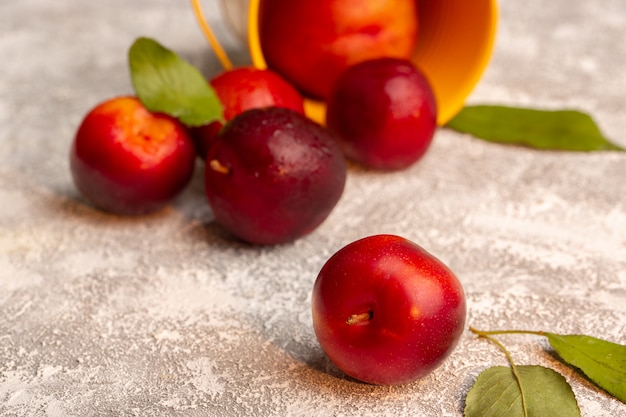 Vista frontal de ciruelas ácidas frescas color de la fruta madura suave