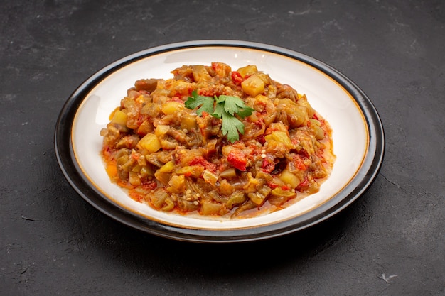 Vista frontal deliciosa comida vegetal en rodajas plato cocido dentro de la placa sobre fondo gris comida comida salsa sopa cena vegetal