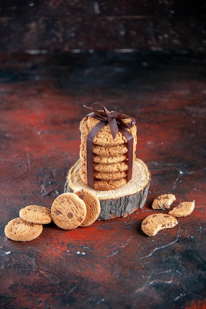 Foto gratuita vista frontal deliciosas galletas dulces atadas con lazo en la oscuridad