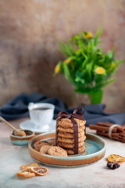 Vista frontal deliciosas galletas dulces atadas con lazo en la superficie ligera postre dulce galletas de azúcar pasteles té masa horizontal