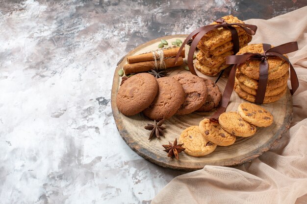Vista frontal deliciosas galletas dulces sobre fondo claro color cacao azúcar pastel de té pastel de galleta dulce