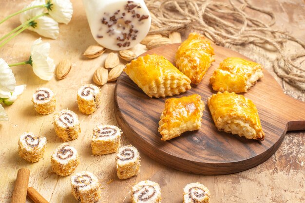 Vista frontal de deliciosos pasteles de nueces con nueces sobre superficie de madera