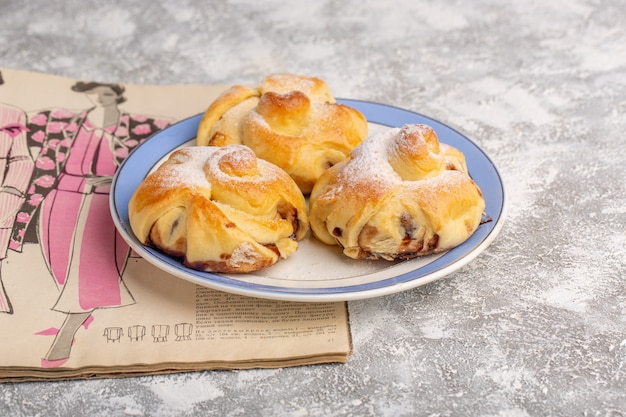 Foto gratuita vista frontal deliciosos pasteles con relleno dentro de la placa sobre la mesa blanca, pastel de azúcar dulce hornear fruta de pastelería