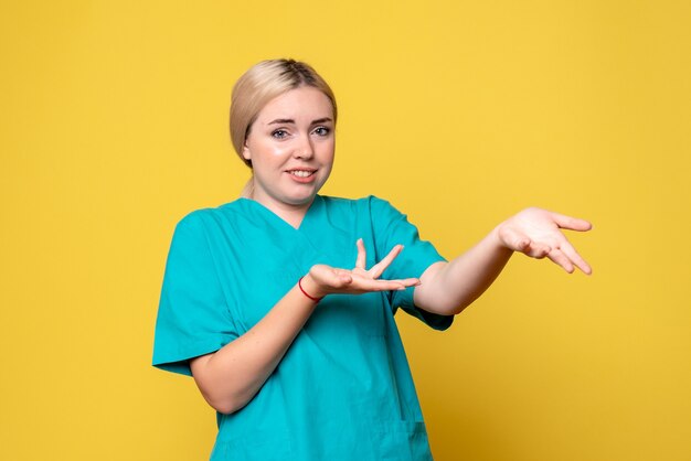 Vista frontal doctora en camisa médica, enfermera de covid pandémica de emoción de médico