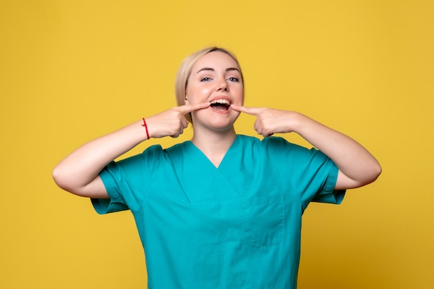 Vista frontal doctora en camisa médica, enfermera médico emoción pandemia