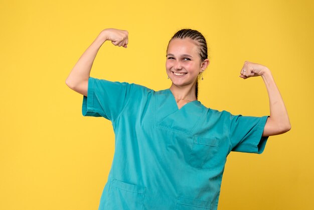 Vista frontal doctora en camisa médica flexionando, enfermera de salud covid-19 hospital virus emoción