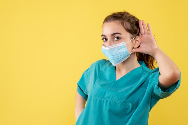 Vista frontal doctora en camisa médica y máscara estéril, uniforme de virus de salud de color covid-