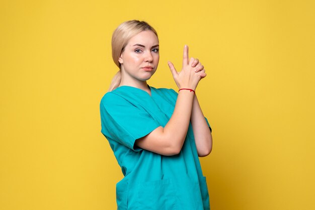 Vista frontal doctora en camisa médica posando, enfermera pandémica médico covid-19 emoción