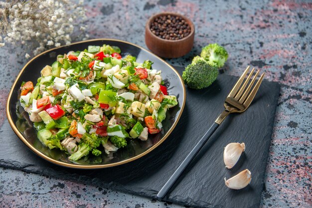 Vista frontal de ensalada de verduras con un tenedor en la superficie oscura restaurante de comida sana cocina de color dieta de almuerzo maduro