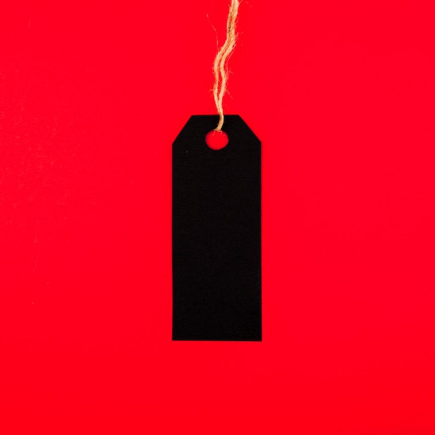 Vista frontal de la etiqueta negra sobre papel rojo