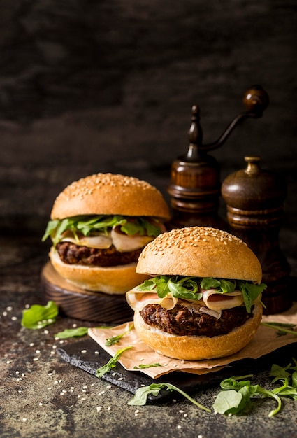 Vista frontal hamburguesas de carne fresca con tocino en tablero de pizarra