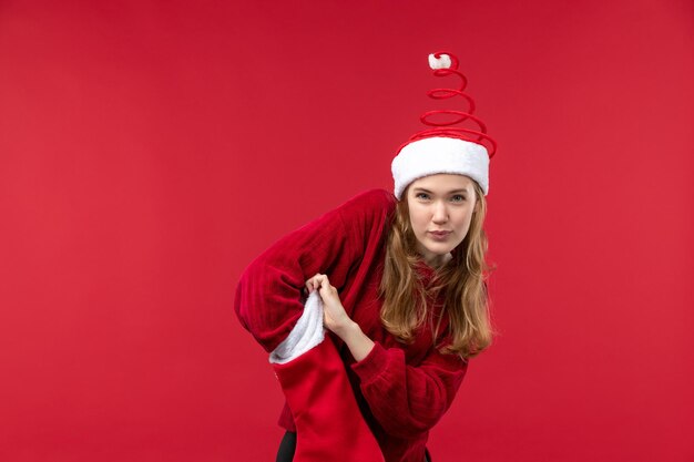 Vista frontal de las hembras jóvenes comprobando el calcetín rojo de Navidad, vacaciones de Navidad rojo