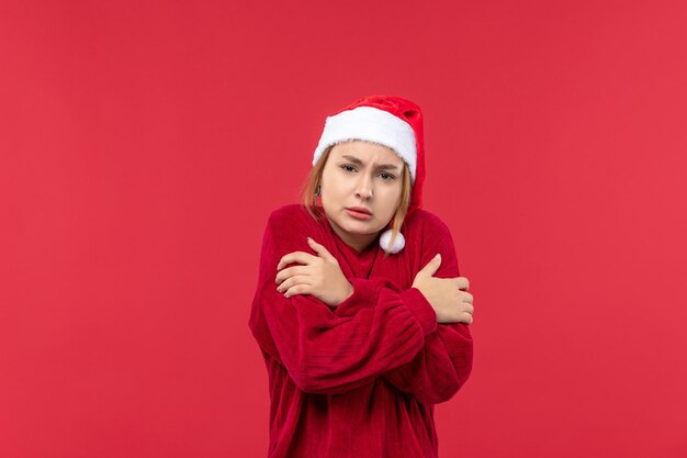 Vista frontal de las hembras jóvenes temblando de frío, rojo navideño de vacaciones