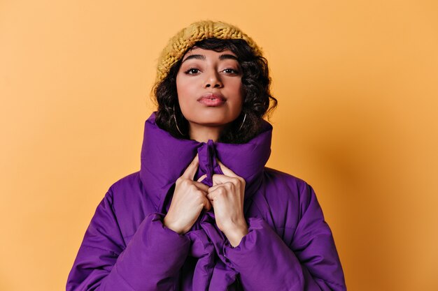 Vista frontal de la hermosa joven con gorro de punto