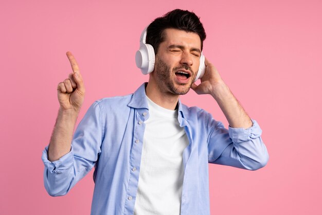 Vista frontal del hombre disfrutando de la música en sus auriculares