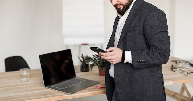 Foto gratuita vista frontal del hombre de negocios con teléfono