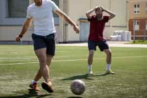 Foto gratuita vista frontal hombres jugando al fútbol