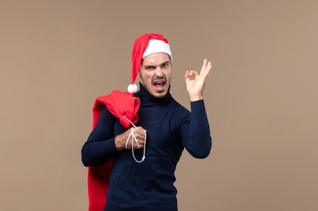 Vista frontal joven con bolsa presente, santa vacaciones navidad