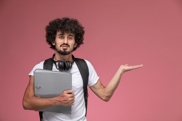 Vista frontal joven dando la mano vacía y sosteniendo la carpeta