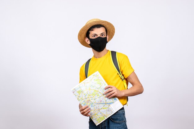 Vista frontal joven guapo con máscara y camiseta amarilla con mapa