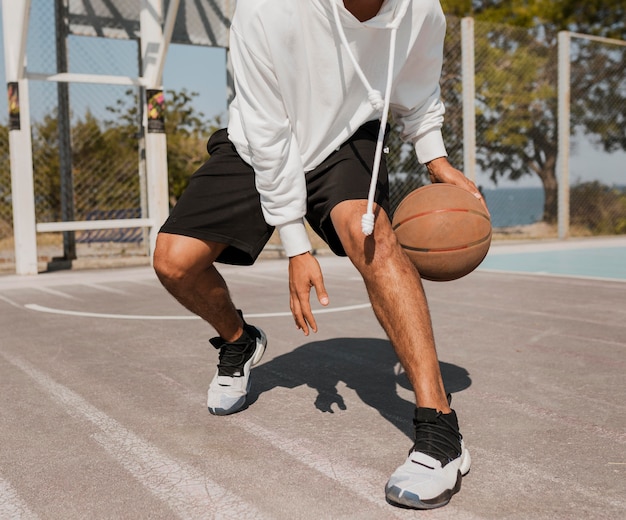 Vista frontal joven jugando baloncesto