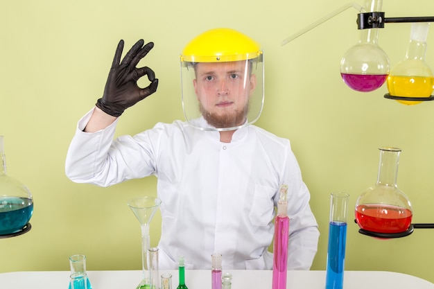 Vista frontal joven químico le gusta su casco en un laboratorio