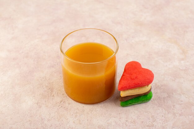 Vista frontal de jugo de durazno fresco dulce y delicioso con galletas de colores