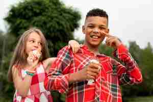 Foto gratuita vista frontal de lindos amigos comiendo helado