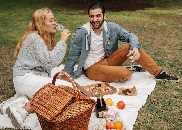 Vista frontal marido y mujer haciendo un picnic en el parque