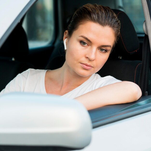 Vista frontal de la mujer en auto personal