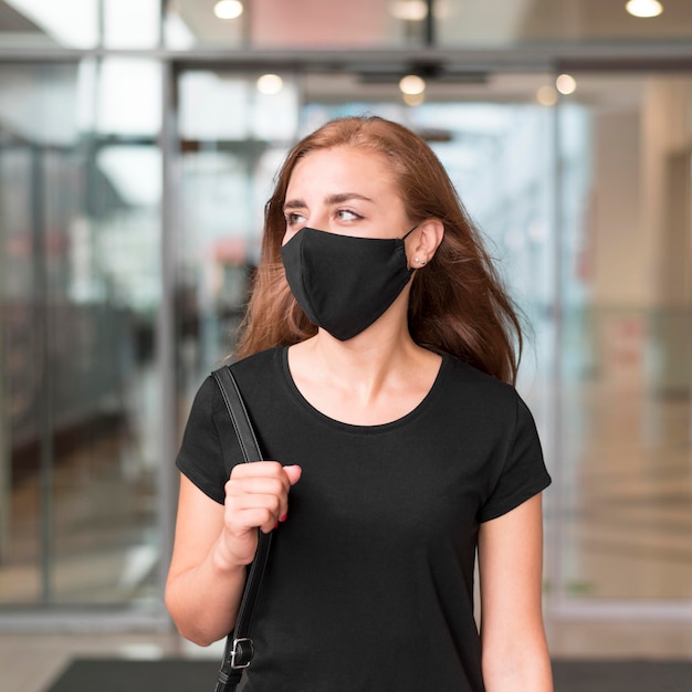 Foto gratuita vista frontal de la mujer en el centro comercial con máscara