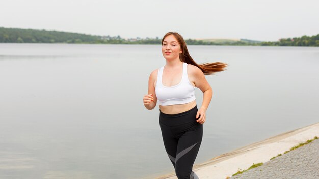 Vista frontal, de, mujer, jogging, aire libre