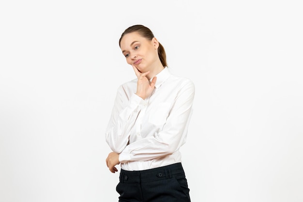 Vista frontal mujer joven en elegante blusa blanca con cara de pensamiento sobre fondo blanco mujer trabajo de oficina señora trabajadora