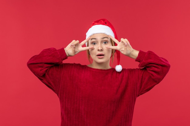 Foto gratuita vista frontal mujer joven con expresión posando, vacaciones rojo navidad