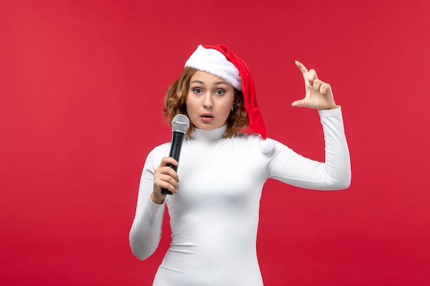Foto gratuita vista frontal de la mujer joven con micrófono en rojo