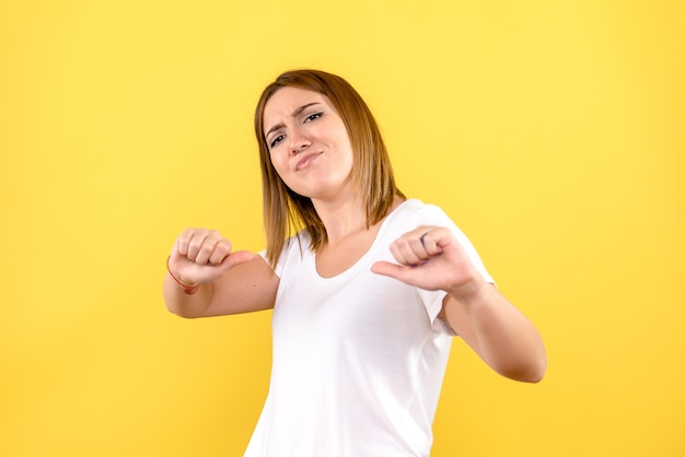 Vista frontal, de, mujer joven, en, pared amarilla