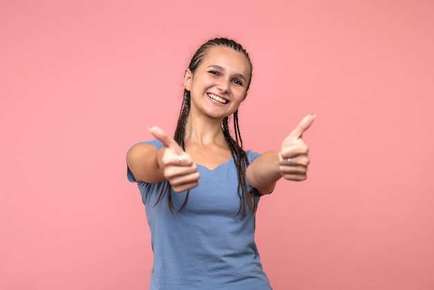 Foto gratuita vista frontal de la mujer joven sonriendo ampliamente en rosa