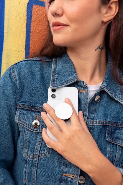 Foto gratuita vista frontal mujer joven usando popsocket