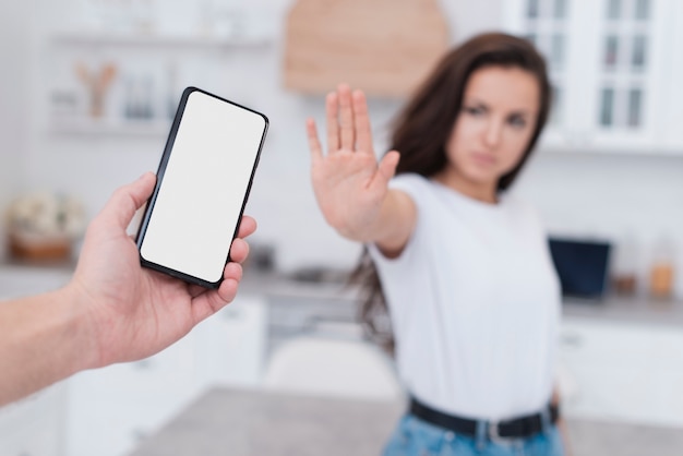 Vista frontal mujer negándose a sostener un teléfono