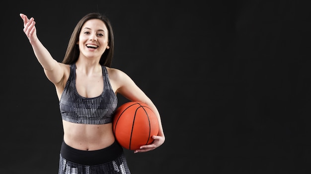 Vista frontal de la mujer con pelota de baloncesto