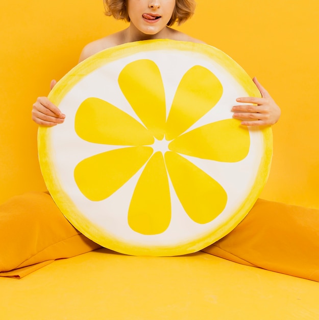 Foto gratuita vista frontal de la mujer posando con decoración de rodaja de limón