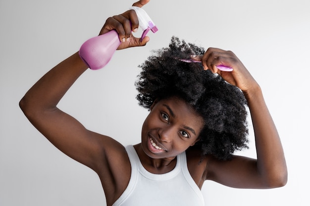 Vista frontal mujer sonriente arreglando el cabello